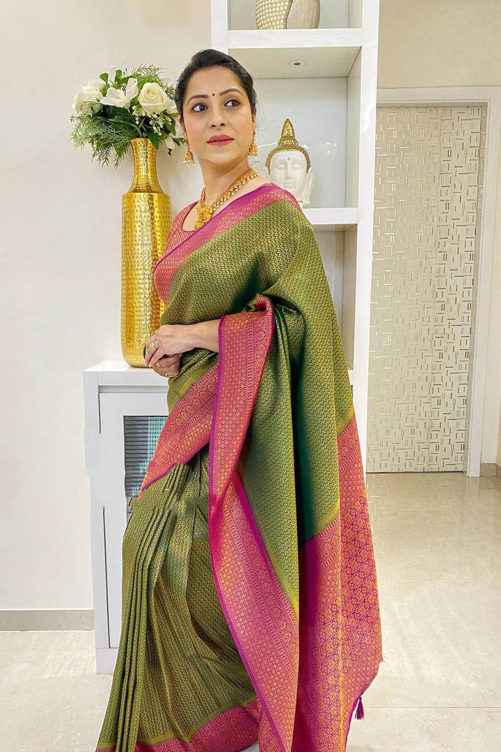 Adoring Green Soft Silk Saree With Cynosure Blouse Piece