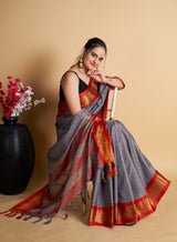 grey designer silk aura base with contras blouse and pallu.